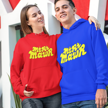 Load image into Gallery viewer, A man and a woman standing outdoors in front of a modern white and red geometric building. The woman wears a red hoodie with yellow 'mri mawr' text, and the man wears a blue hoodie with yellow 'miri mawr' text.