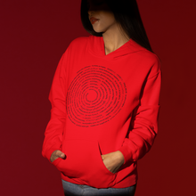Load image into Gallery viewer, A model wearing a bright red hoodie with a black circular concentric text graphic on the front, paired with black pants, set against a solid dark red background.