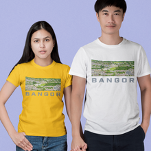 Load image into Gallery viewer, A man and a woman standing side by side holding hands, wearing matching graphic t-shirts with a landscape photo and the word 'BANGOR' printed on the front. The woman wears a mustard yellow t-shirt and ripped blue jeans, while the man wears a white t-shirt and dark navy shorts.