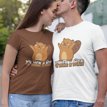 Load image into Gallery viewer, A couple wearing matching graphic t-shirts with a beaver design and Ukrainian text, posing outdoors on a paved path with trees in the background.